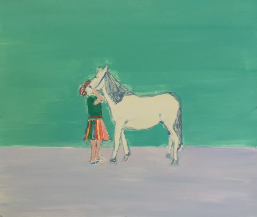 A girl wearing a stripy skirt holding a white horse.