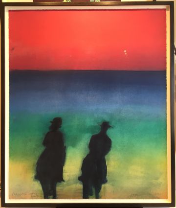 The silhouette of two riders in a multi-coloured landscape and red sky.