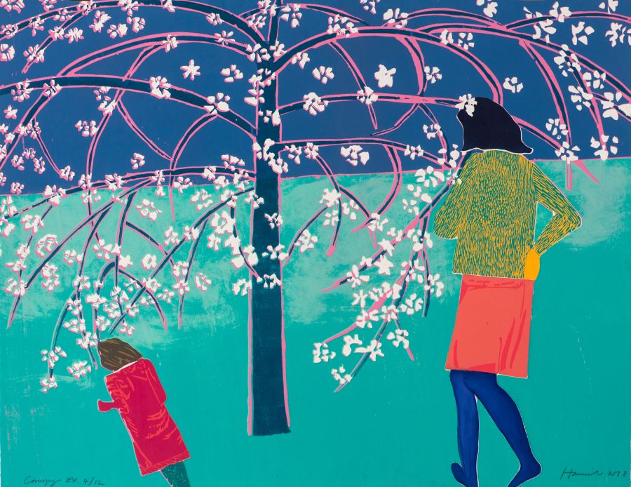 Woman and child standing under blossom tree.