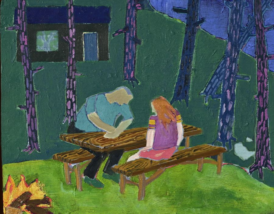 Two figures sitting at a table in the woods.