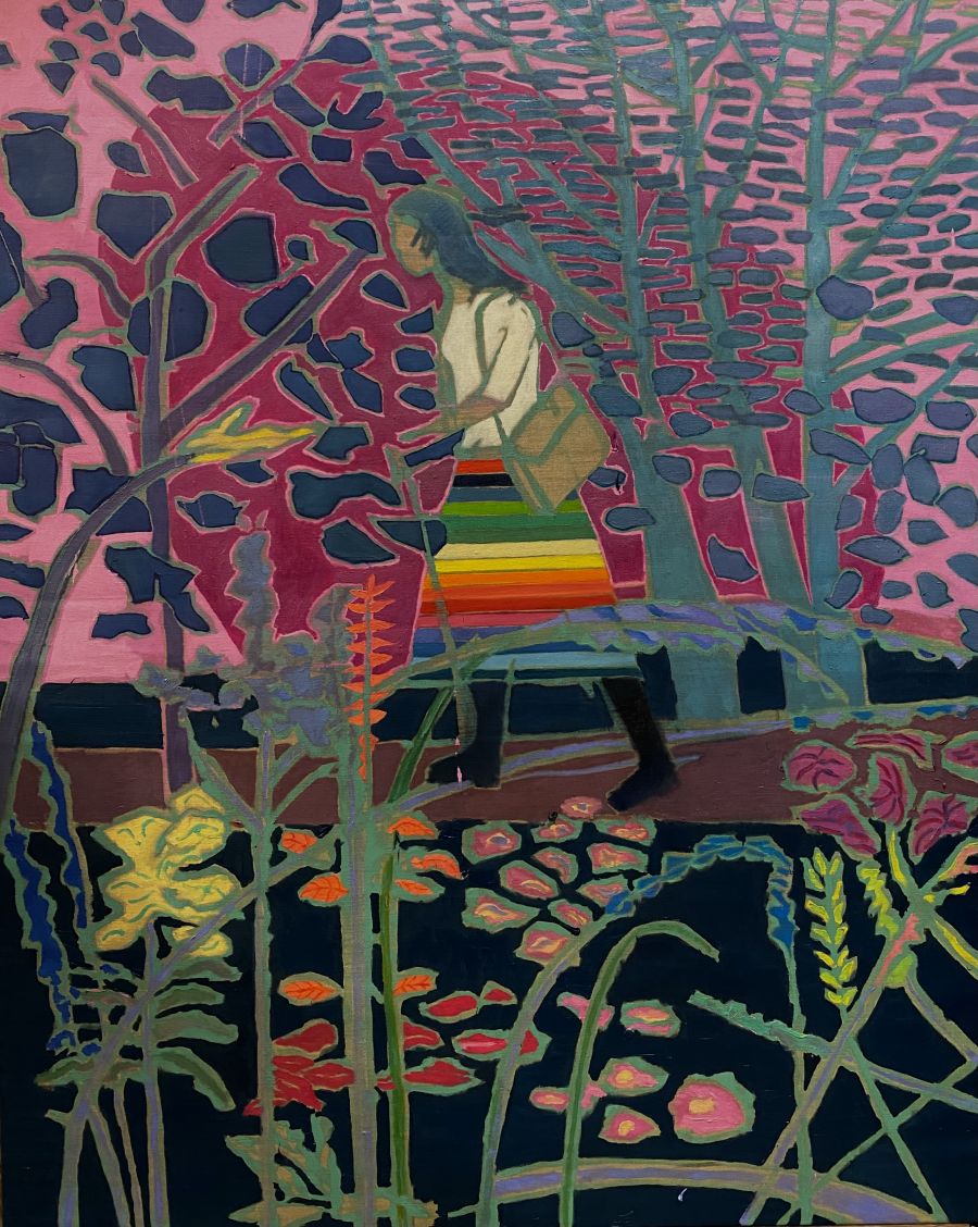 Figure of a woman walking through a colour woodland wearing a multicoloured skirt.