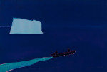 Boat passing iceberg