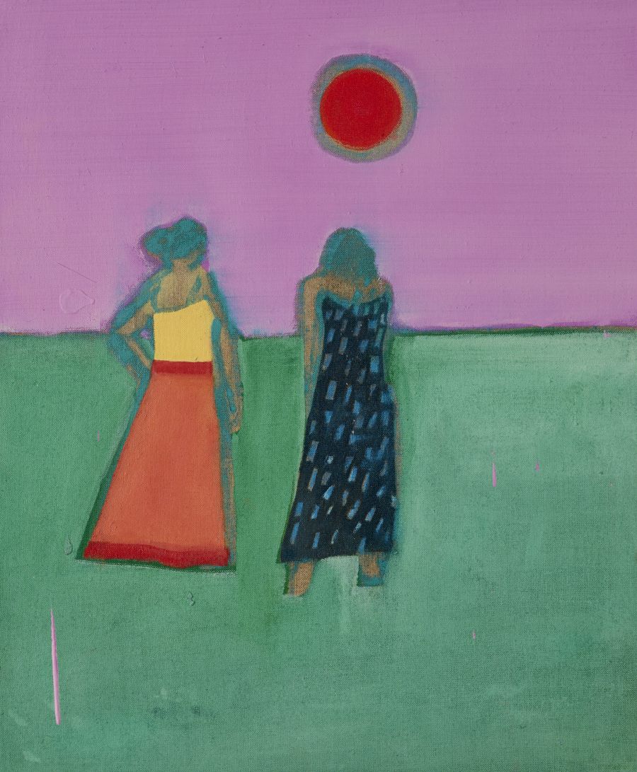 Two women standing looking at the red full moon..